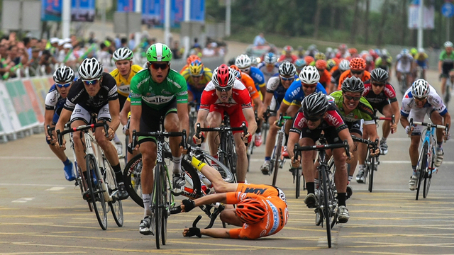 But it was all going so well.. Tom Palmer (centre, red) caught behind a crash at the Tour of Hainan. (Supplied)
