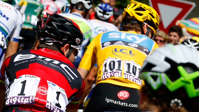 Australia's Cadel Evans (L) rides behind Bradley Wiggins (yellow) on the final stage of the Tour de France (Getty)