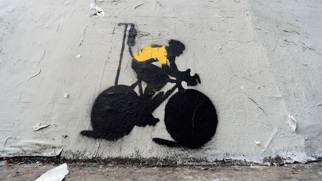 Stencil art depicting Lance Armstrong attached to an IV drip pictured on the side of a building in Los Angeles (Getty)