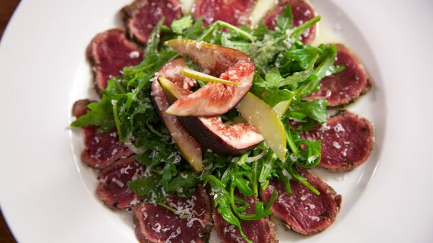 Carpaccio of fallow deer with rocket, pear, fig and parmesan salad