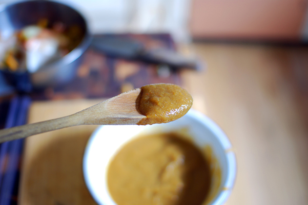 a spoon covered in light brown barbecue sauce