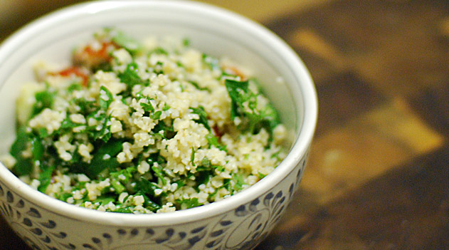 small bowl of cracked wheat salad, tabouleh, on a wooden table