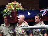 Soldier laid to rest as son is born