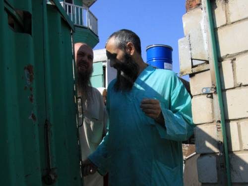 Members of an underground sect in Russia's Volga River province of Tatarstan province stand at the gate of a house outside the provincial capital, Kazan. (AAP)