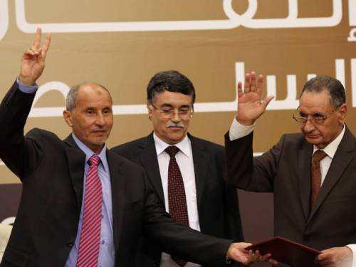 Libya's National Transitional Council's chief, Mustafa Abdel Jalil (L), Kamal Edhan the President of the Supreme Court in Libya (C), Mohammad Ali Sulayem, Chairman of the National Conference (R) during the transfer of authority ceremony in Tripoli. (Getty)