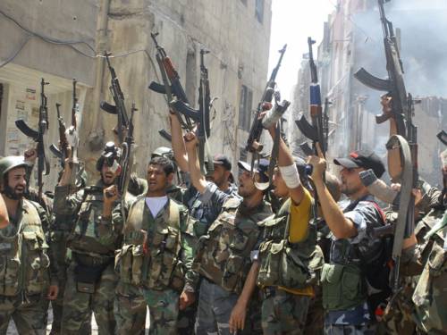 Syrian soldiers celebrate after routing rebel fighters in the al-Midan area in Damascus, Syrian state television reported. (AAP)
