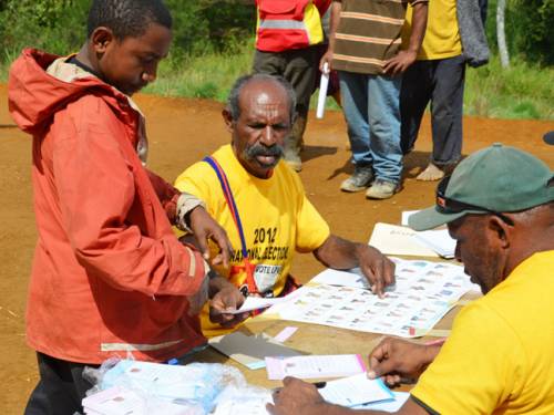 A teenage boy casts a ballot in Tebi, a village near Tari in Papua New Guinea's highlands. (AAP)