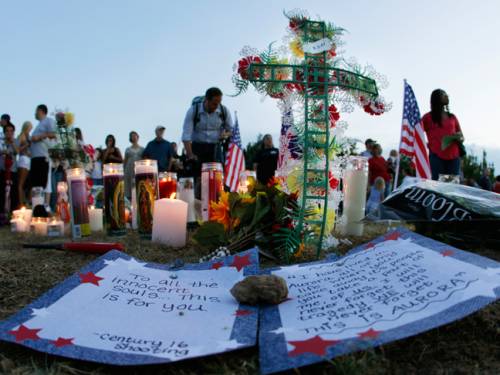 A written message that begins 'To all the innocent souls... this is for you,' is shown near a display of candles, flags, and other tributes. (AAP)