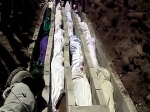 MASSACRED: A grab from a video published by Sham News Network on a social network on 26 May 2012, shows bodies of Syrians killed one day earlier being made ready for a mass funeral in Houla, Homs, Syria.