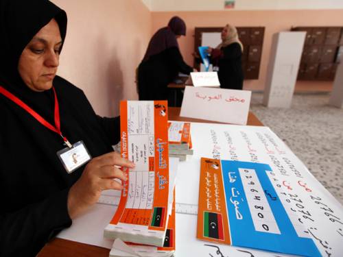 A Libyan polling station worker checks electoral material at a school in the Tajura district of Tripoli. (Getty)