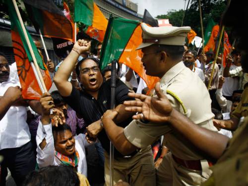 Indian policemen detain activists of the opposition Bharatiya Janata Party during a protest in Mumbai. (AP)