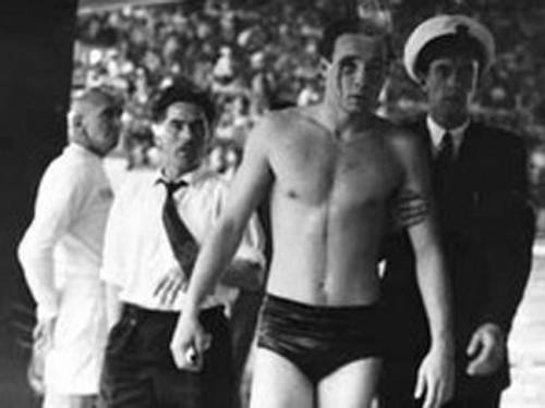 Ervin Zador from Hungary emerges from the pool with blood streaming down his face at the Hungary v USSR waterpolo semi-final in the 1956 Melbourne Olympics. Image courtesy of Public Record Office of Victoria.
