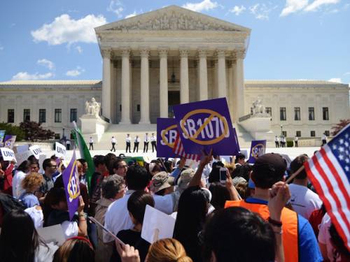 More than 1,000 protesters outside the court lashed out against provisions of the law, known as SB1070. (Getty Images)
