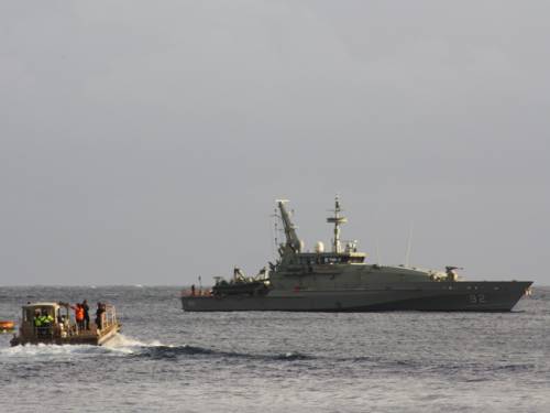 An Australian naval ship delivers asylum seekers from the wreck site to safety at Christmas Island's detention centre (AAP)