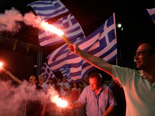 Supporters of the 'New Democracy' political party light flares during a rally ahead of Sunday's general election. (Getty)