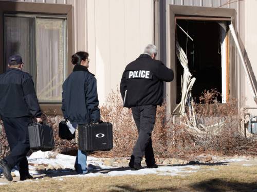 Aurora Police Crime Scene Detectives prepare to enter a townhouse in Aurora, Colorado. (EPA)