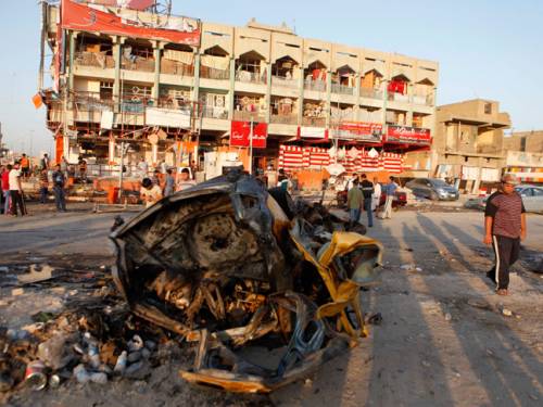 People inspect the aftermath of an overnight car bomb attack in Baghdad's Shiite enclave of Sadr City, Iraq. (AAP)