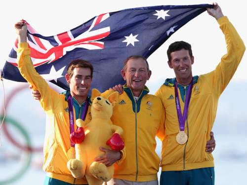 Mathew Belcher and Malcolm Page celebrate their win with their coach Victor Kovalenko. (AAP)