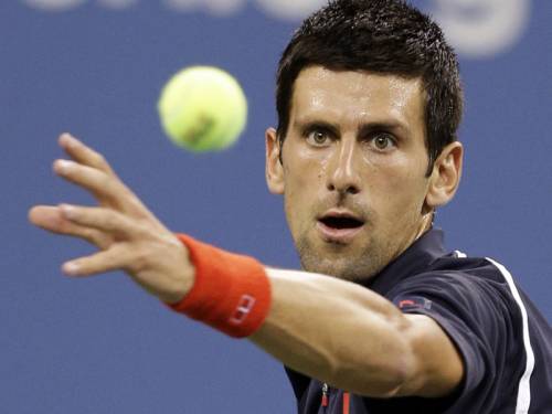 Novak Djokovic (pic) opened his US Open title defence with a 6-1 6-0 6-1 thrashing of Paolo Lorenzi. (AAP)