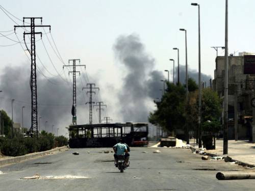 Activists said massive explosions echoed across much of the city and a video released by one opposition group showed a vast plume of smoke billowing into the sky. (AAP)