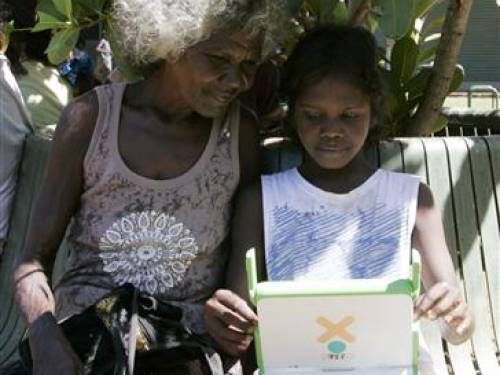 An Australian aboriginal school child works on a laptop computer as part of the