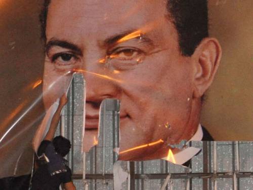 Mubarak's image being defaced during the early days of the revolution. (AP)