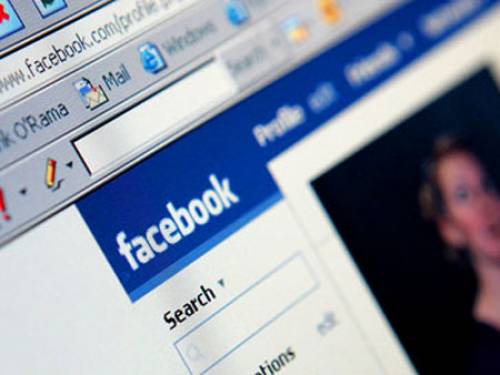 An Israeli soldier has used Facebook to post pictures of herself with handcuffed Palestinians. 