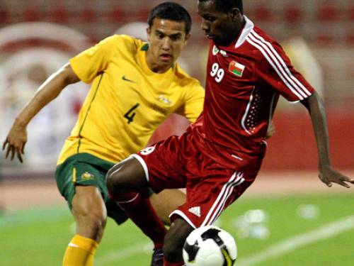 Tim Cahill battles with Oman's Qassim Said in Oman. (AFP)