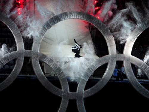 A snowboarder leaps through the Olympic Rings at the Opening Ceremony. (EPA)
