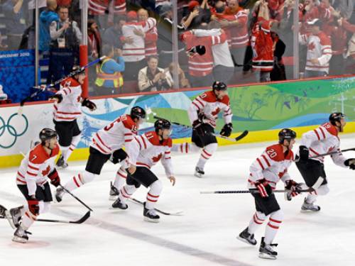 Canada players react after the winning goal in the overtime period of the men's gold medal ice hockey game at the Vancouver 2010 Olympics. (AP)