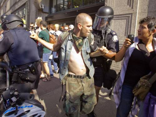 A demonstrator faces police in riot gear near the G20 site in Toronto (Getty Images) 