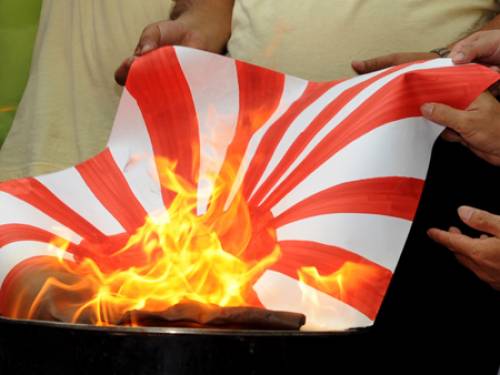Protesters burn a Japanese war-time flag in Hong Kong last week. (AFP)