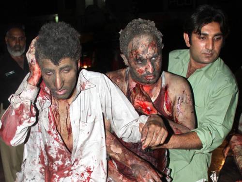 People who were injured in two back-to-back bomb explosions are rushed to hospital in Peshawar, Pakistan. (EPA)