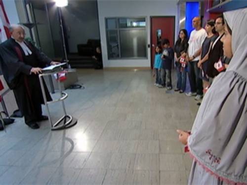 A video still of the citizenship ceremony aired on Canadian TV where government employees posed as 