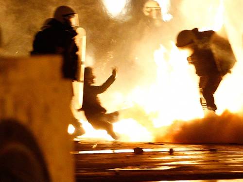 Deputies defied 100,000 demonstrators in Athens and Thessaloniki to pass another round of stringent budget measures. (Getty)