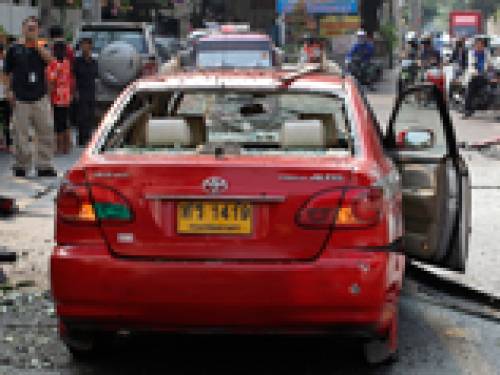 One man hurled an explosive device at a taxi that refused to stop, triggering a blast that tore off his legs, police said. (AAP)