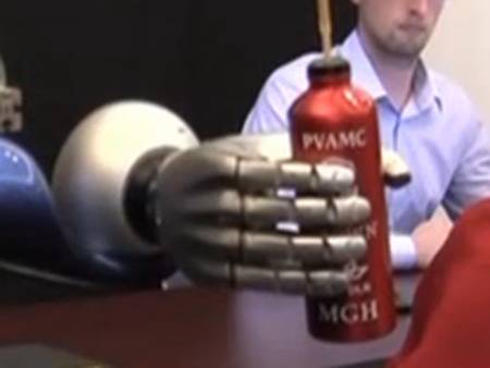 Paralysed woman's mind works robotic arm