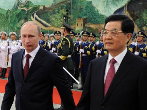 Chinese President Hu Jintao and Russian President Vladimir Putin walk after reviewing an honour guard during a welcoming ceremony at the Great Hall of the People in Beijing. (Getty Images)