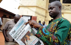 A man reads up on election results in Nigeria earlier this year. (AFP) 