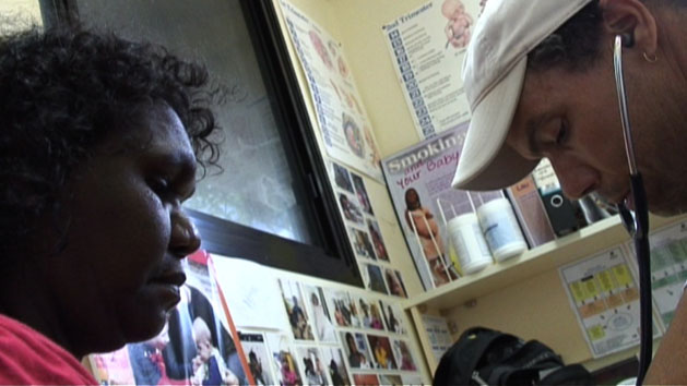 A doctor from the Indigenous Cardiovascular Outreach Program treating a patient