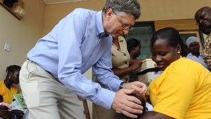 Microsoft founder Bill Gates gives a Ghanaian child a rotavirus vaccination